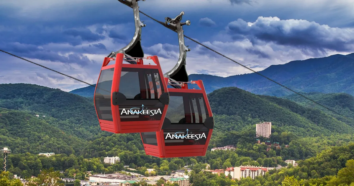 An exciting view of gondolas gliding above forested mountains under a bright sky, offering a thrilling perspective of the Smoky Mountain landscape. This image showcases a popular local activity and the scenic beauty of the region.